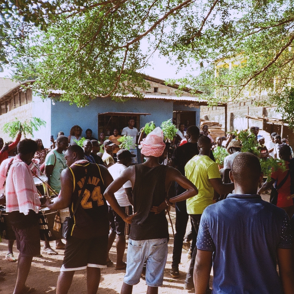 crowd gathered for party in the dirt streets of Bissau
